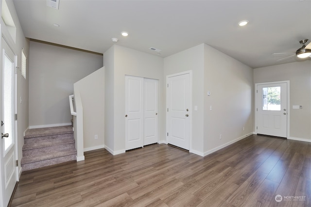 foyer with ceiling fan and wood-type flooring