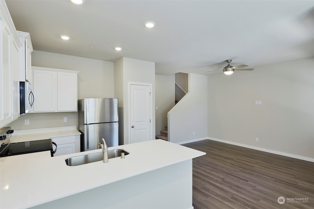 kitchen with stainless steel appliances, ceiling fan, sink, dark hardwood / wood-style floors, and white cabinetry