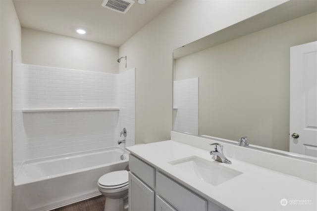 full bathroom with shower / bathing tub combination, vanity, toilet, and hardwood / wood-style floors