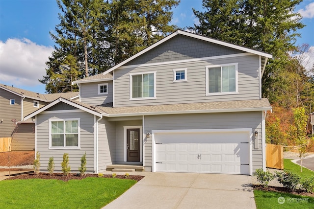 view of front of house featuring a front yard and a garage