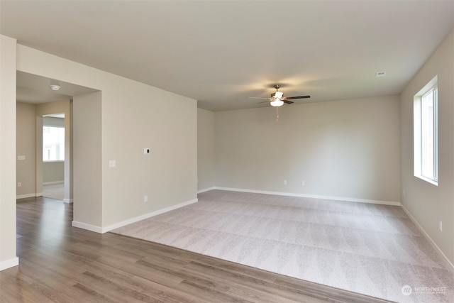 spare room with hardwood / wood-style flooring and ceiling fan