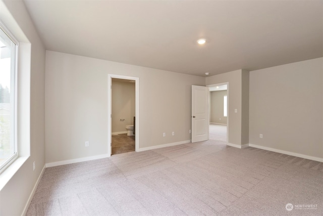 empty room featuring light colored carpet