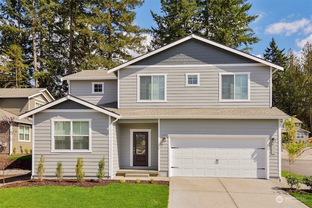 view of front of property featuring a garage and a front lawn