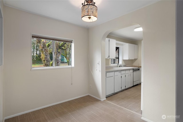 unfurnished dining area featuring light wood-type flooring and sink