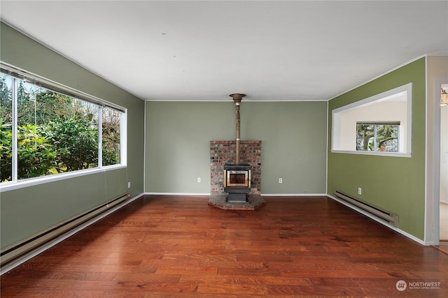 unfurnished living room with dark hardwood / wood-style flooring, a wood stove, and a baseboard radiator