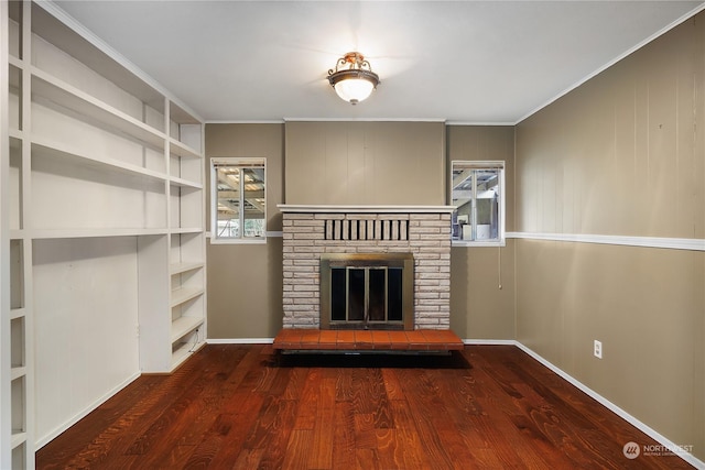 unfurnished living room featuring hardwood / wood-style floors, ornamental molding, and a fireplace