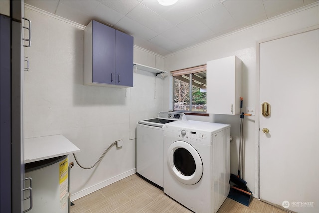 washroom with cabinets and washing machine and clothes dryer