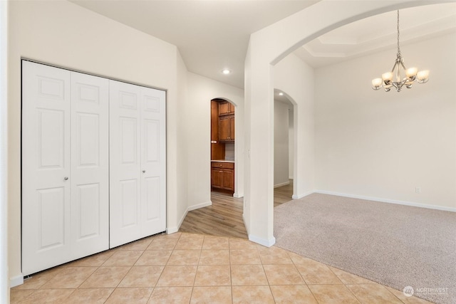 interior space with a chandelier and light colored carpet