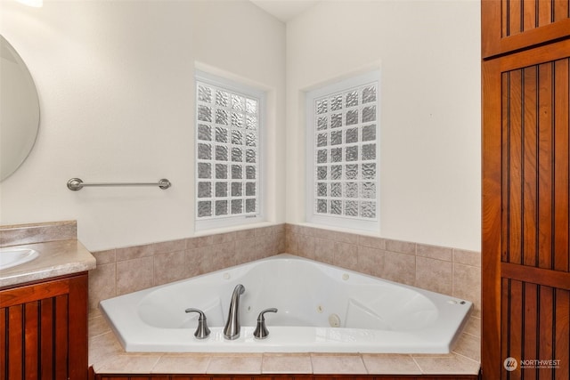 bathroom featuring vanity and a relaxing tiled tub