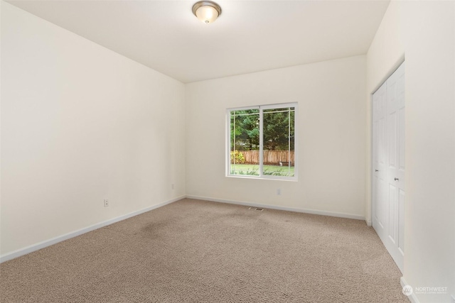 unfurnished room with light carpet