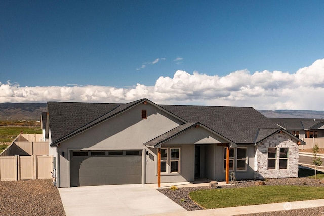 view of front facade featuring a garage and a mountain view