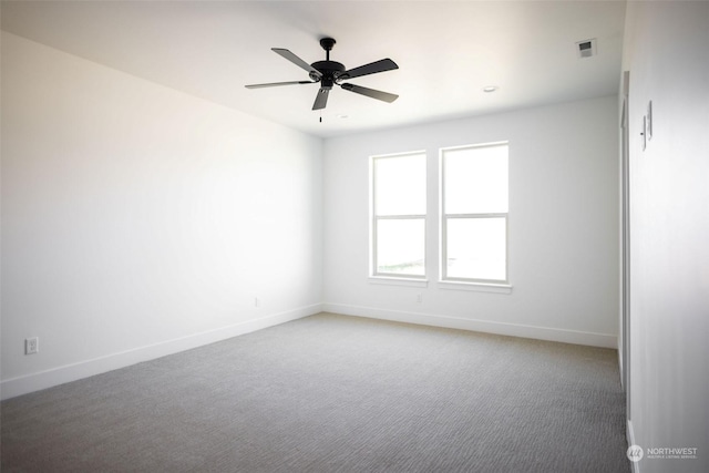 empty room with ceiling fan and carpet floors