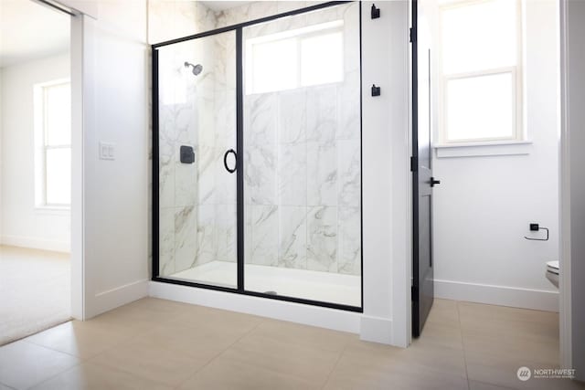 bathroom featuring toilet, tile patterned flooring, and an enclosed shower