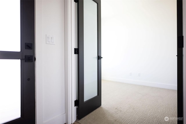 corridor featuring french doors and carpet floors