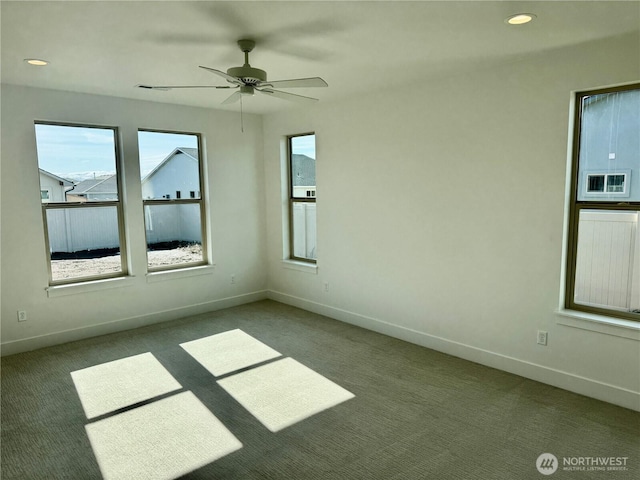 spare room featuring carpet floors, recessed lighting, and baseboards