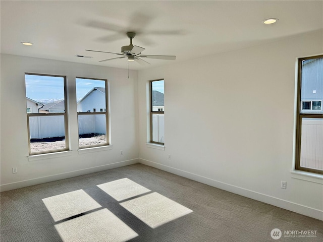 unfurnished room featuring recessed lighting, light carpet, and baseboards