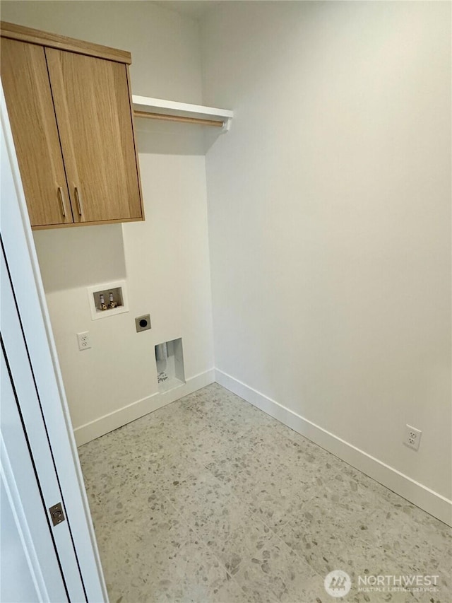 clothes washing area featuring electric dryer hookup, hookup for a washing machine, cabinet space, and baseboards