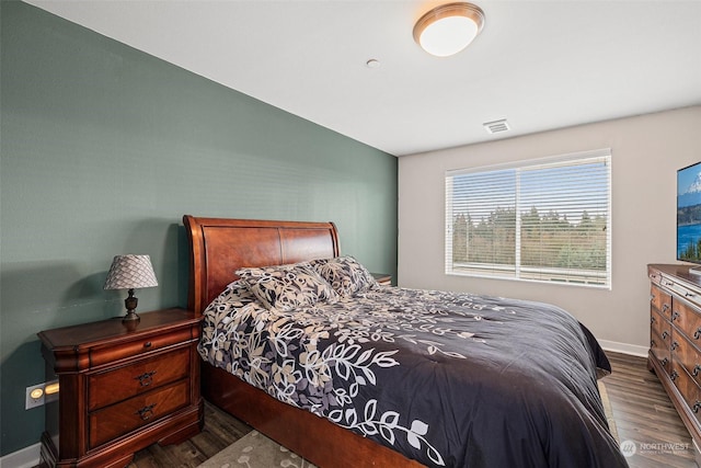 bedroom with dark wood-type flooring