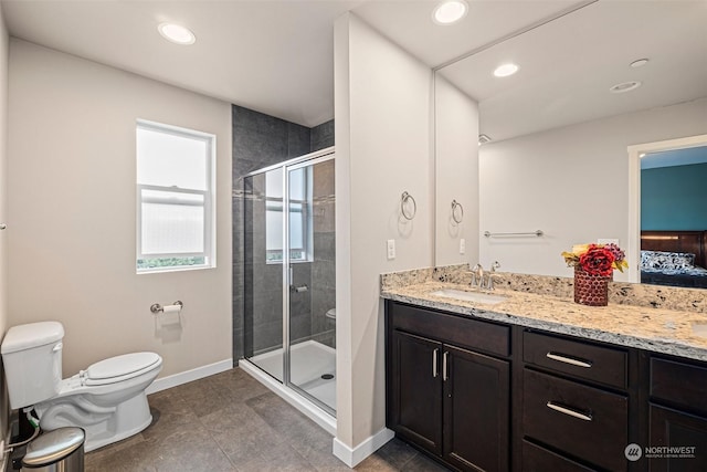 bathroom with tile patterned flooring, vanity, toilet, and walk in shower