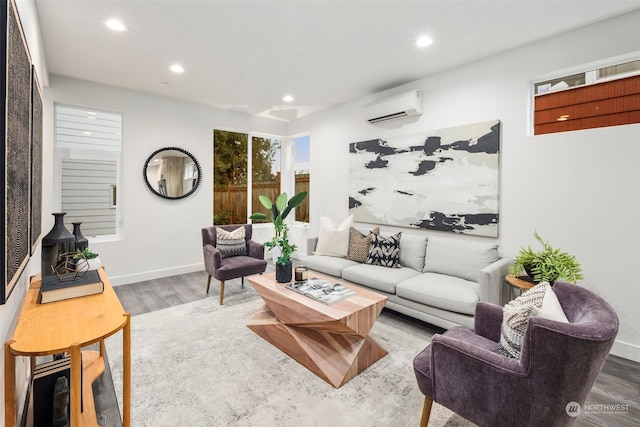 living room with a wall mounted AC and hardwood / wood-style floors