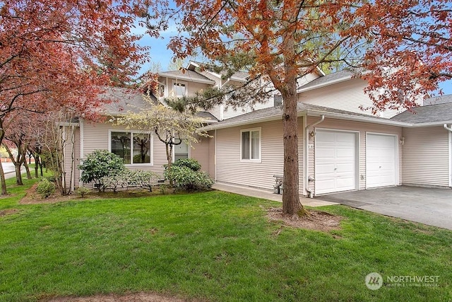 view of front of home featuring a front yard and a garage