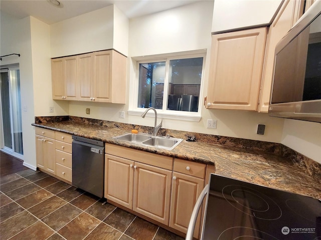 kitchen with sink, appliances with stainless steel finishes, dark stone counters, and light brown cabinetry