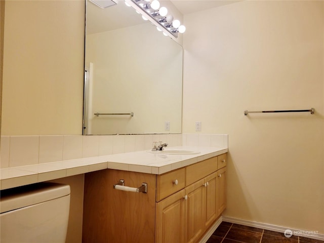 bathroom featuring toilet, tile patterned flooring, and vanity