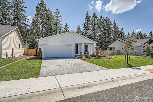 view of front of property featuring a garage and a front lawn