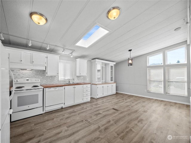 kitchen featuring rail lighting, hanging light fixtures, light hardwood / wood-style floors, white appliances, and white cabinets