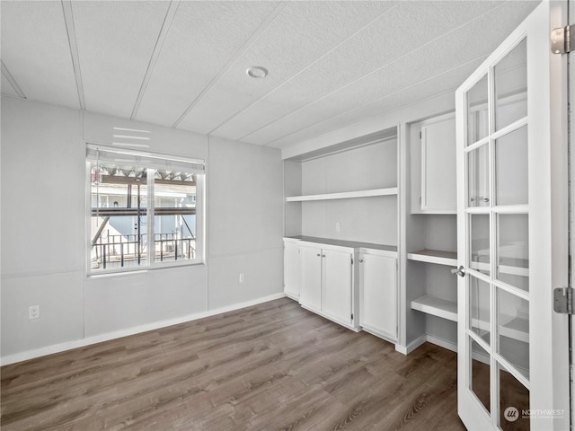 spare room with a textured ceiling and hardwood / wood-style flooring