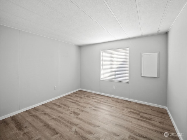 unfurnished room featuring a textured ceiling and hardwood / wood-style flooring