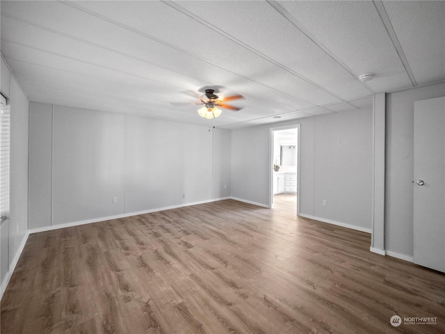 empty room with ceiling fan and wood-type flooring