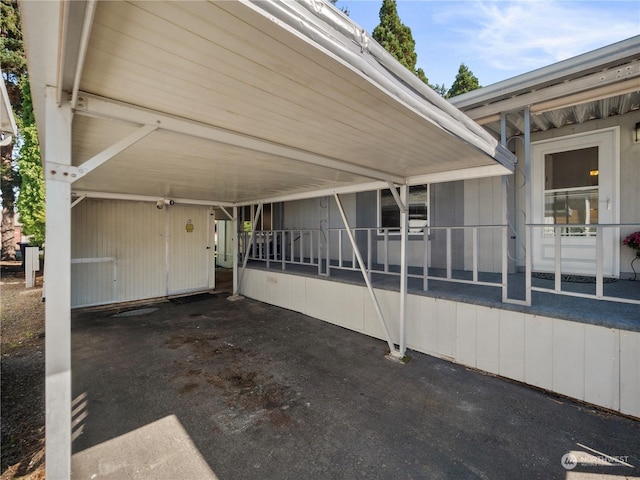 view of parking / parking lot with a carport