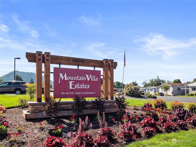 community sign with a mountain view