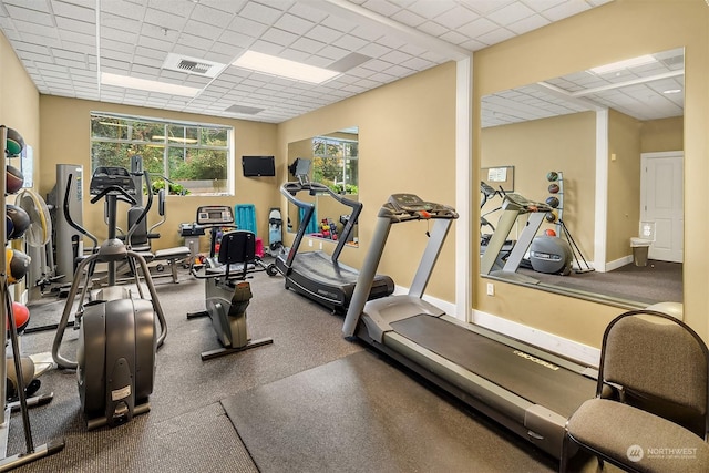 exercise room featuring a drop ceiling