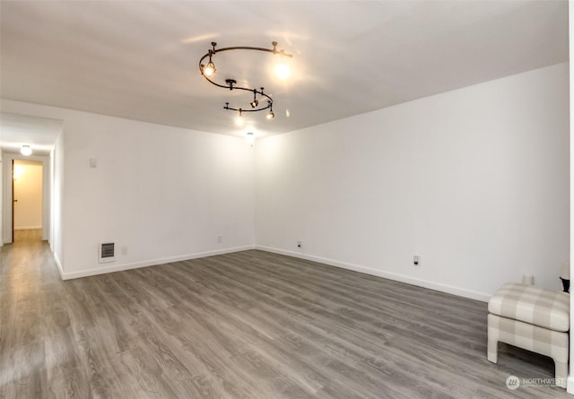 empty room with hardwood / wood-style flooring