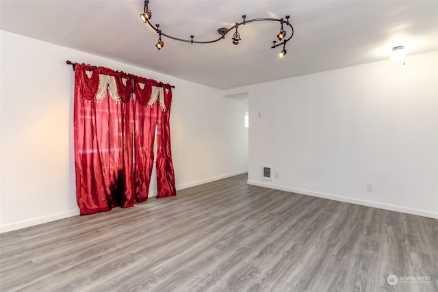 spare room with hardwood / wood-style flooring