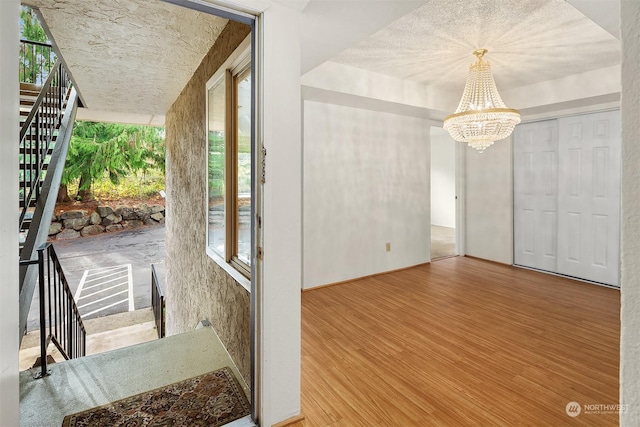 interior space with a chandelier and hardwood / wood-style floors