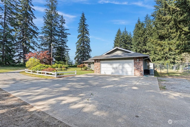 view of front of property with a garage and central air condition unit