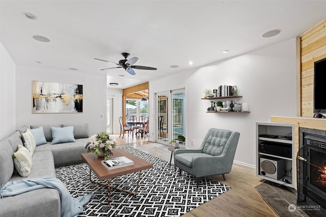 living room featuring ceiling fan and hardwood / wood-style floors