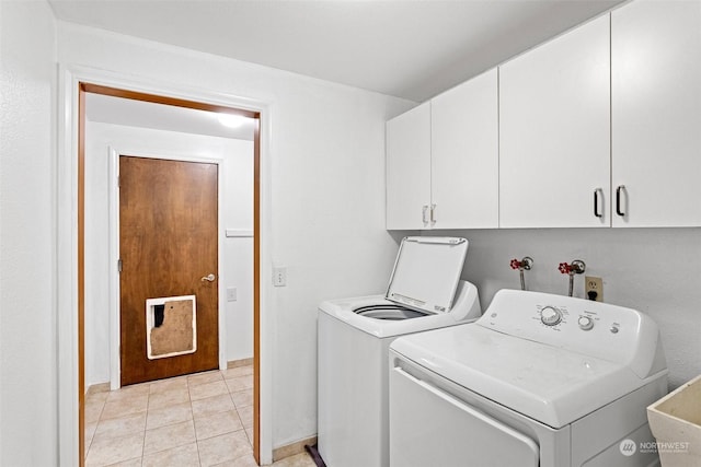 washroom with cabinets, independent washer and dryer, light tile patterned floors, and sink