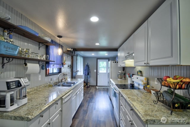 kitchen with dishwasher, stainless steel range with electric cooktop, dark wood-type flooring, white cabinets, and sink