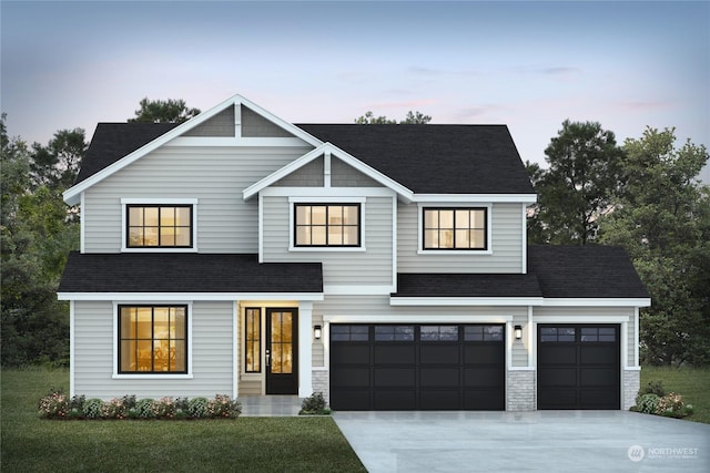 view of front of home featuring a yard and a garage