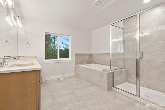 bathroom with tile patterned flooring, vanity, and plus walk in shower