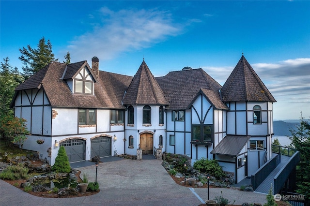 tudor-style house featuring a garage