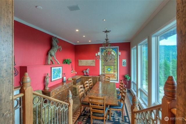 dining area featuring ornamental molding and a notable chandelier