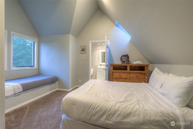 bedroom featuring connected bathroom, carpet floors, and lofted ceiling