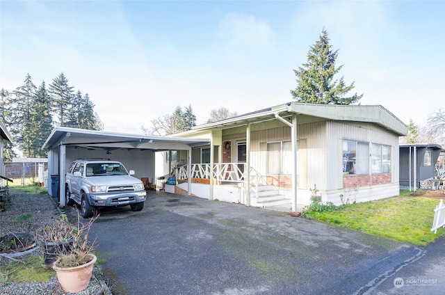 view of front facade featuring a porch and a carport