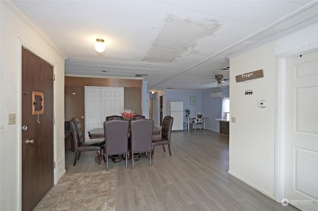 dining area with ceiling fan, wood-type flooring, and ornamental molding