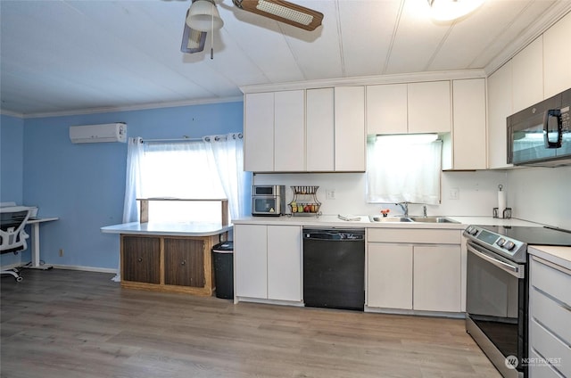 kitchen featuring black appliances, white cabinets, an AC wall unit, sink, and light wood-type flooring